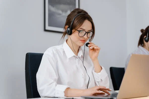 A woman using contact center solutions to call her customer