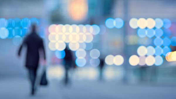 Blurred image of busy workforce walking down city streets