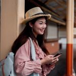 A girl with a hat sending SMS messages