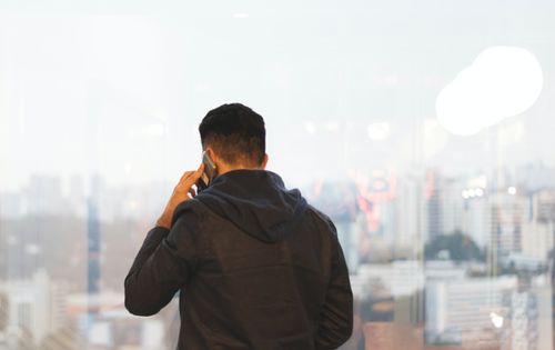 The back of a man talking on a mobile