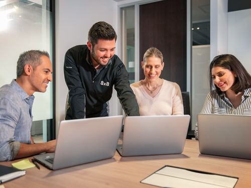 Employees attending a team meeting through cloud communications solutions