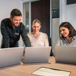 Employees attending a team meeting through cloud communications solutions