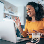 A female contact center agent discussing 8x8’s partner program with a client on a video call.