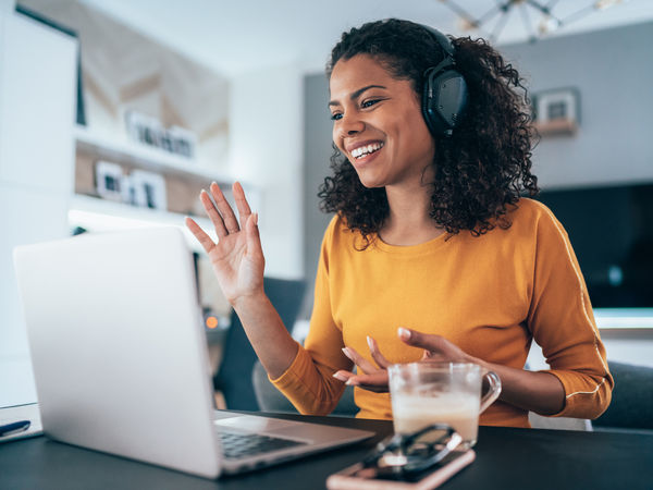 A female contact center agent discussing 8x8’s partner program with a client on a video call.