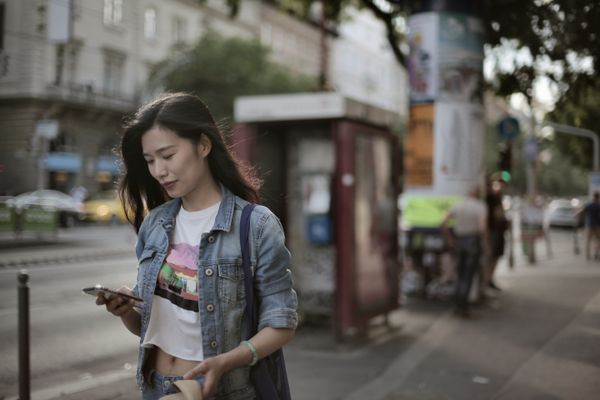 A girl receiving an automate SMS message on her smartphone