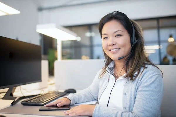 A female employee talking listening to a customer’s needs on a phone call