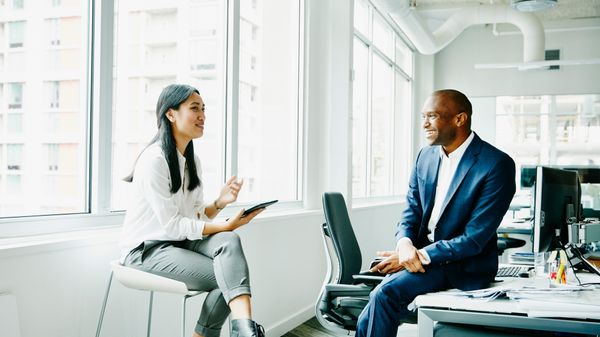 Team lead talking to her employee about 8x8's unified communications platform