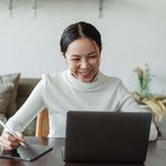 Woman smiling during a video call on her computer