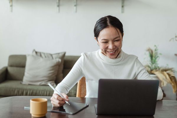 Woman smiling during a video call on her computer