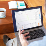 Man on computer studying ROI impact through an analytics dashboard