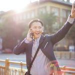 Man on the phone while hailing a cab