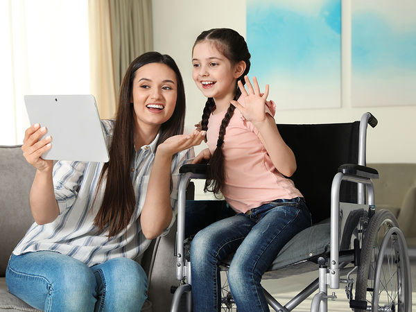 Girl in wheelchair with her mom using the 8x8 mobile app to get social services