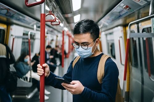 Man using his phone on the train