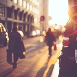 Woman using the phone as she walks down the streets