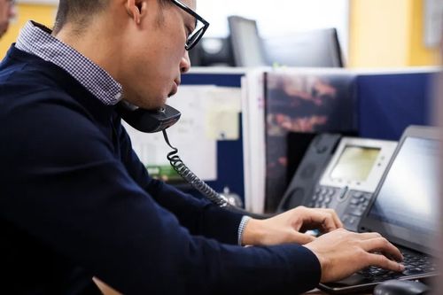 Office worker using a VoIP phone