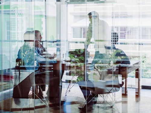 Data security professionals ina meeting room with highly-reflective windows