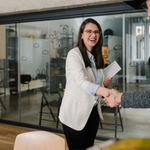 Woman and man shaking hands before conducting an interview for professional services fit