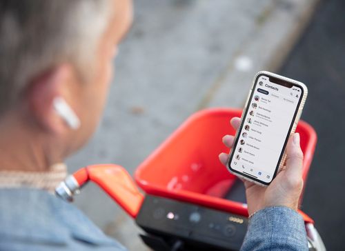 Businessman using the 8x8 app to connect with his team while away from the office