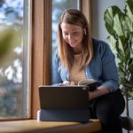 Woman working from home using 8x8's resilient and reliable communications system