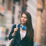 Woman walking while using safe and secure communications solutions.