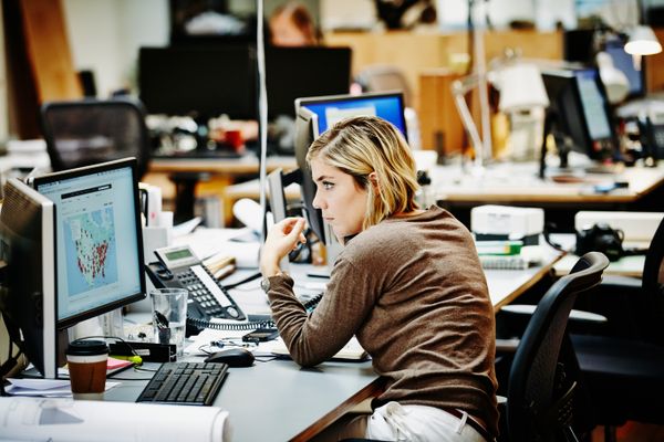 A customer service representative analyzing customer data on their desktop screen.