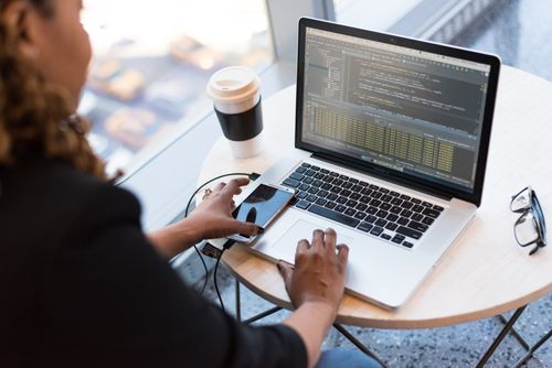 Woman using cloud computing software on a laptop