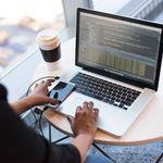 Woman using cloud computing software on a laptop