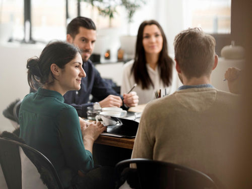 A group of 4 in a meeting