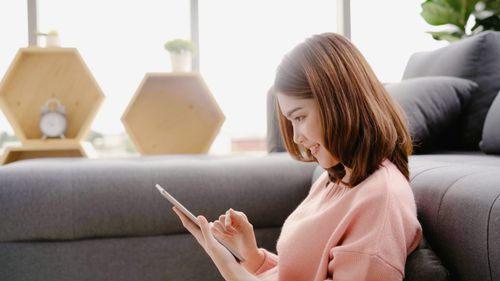 Woman looking down at smartphone