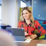 Woman using 8x8 application across devices to access cloud communications and work from anywhere