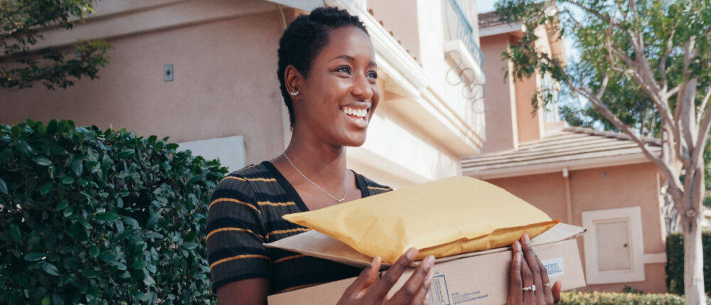 A young girl smilingly hold her orders.