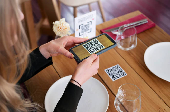 A girl is scanning a restaurant QR code for an online menu.