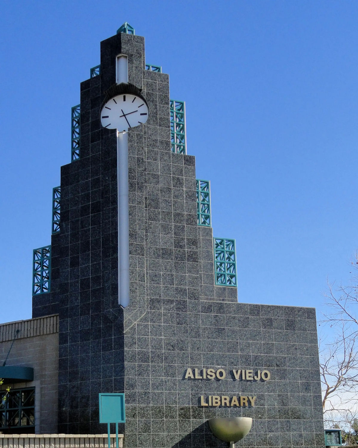 The Aliso Viejo Library clock tower rising above the city's civic plaza on a sunny day.