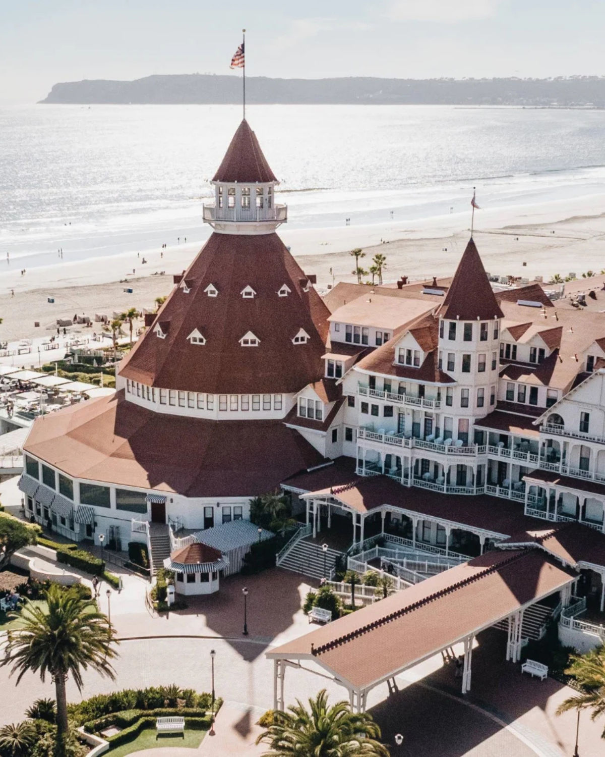 The Hotel del Coronado with its iconic red roofs and Victorian-style architecture along Coronado Beach.