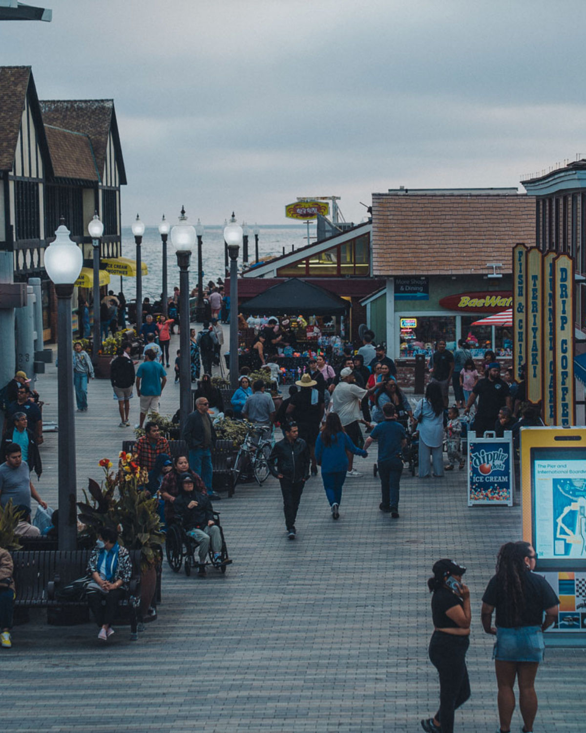 The Redondo Beach Pier extending over the ocean with waterfront shops and a wide beach below.