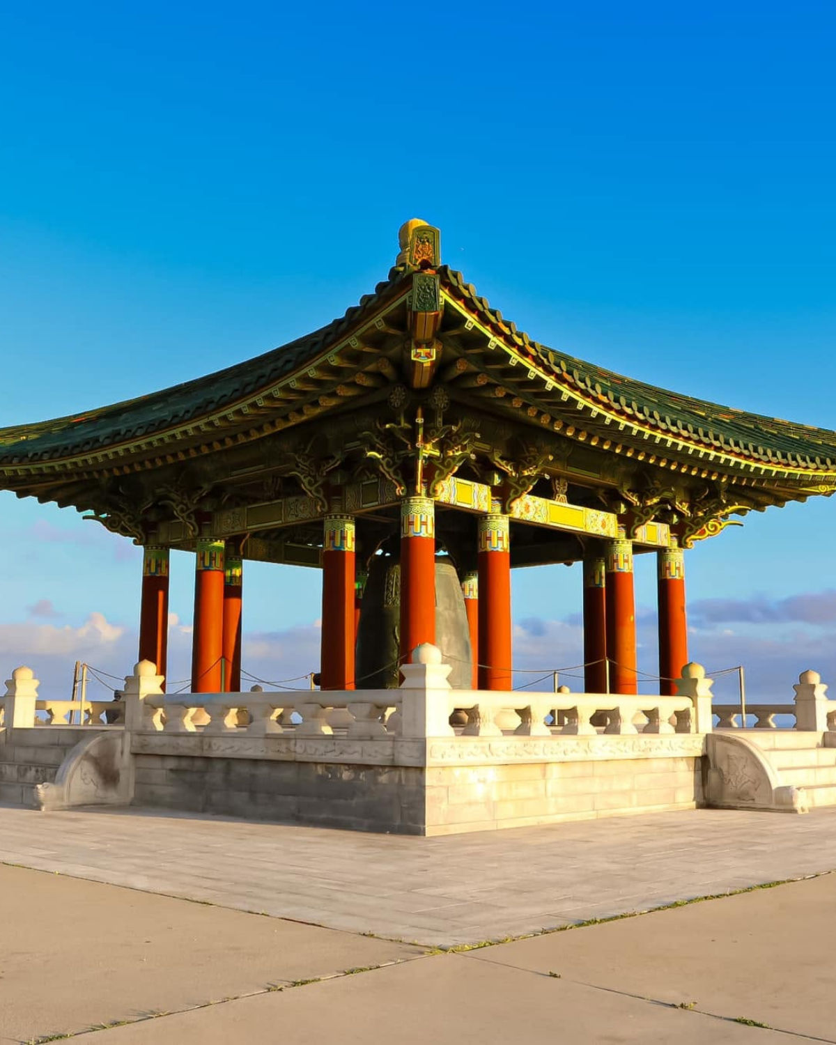 Korean Bell of Friendship and Point Fermin Lighthouse reflect San Pedro's harbor views and coastal landmarks.