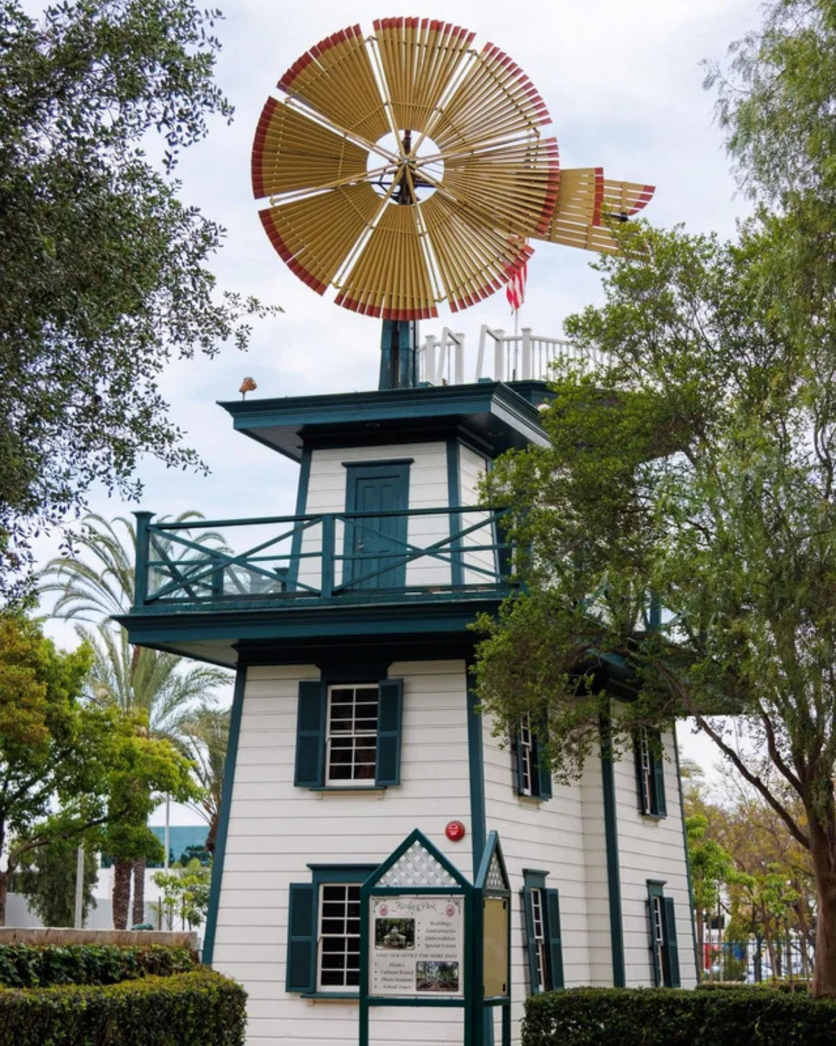 Heritage Park in Santa Fe Springs with restored historic buildings, a train caboose, and landscaped grounds.