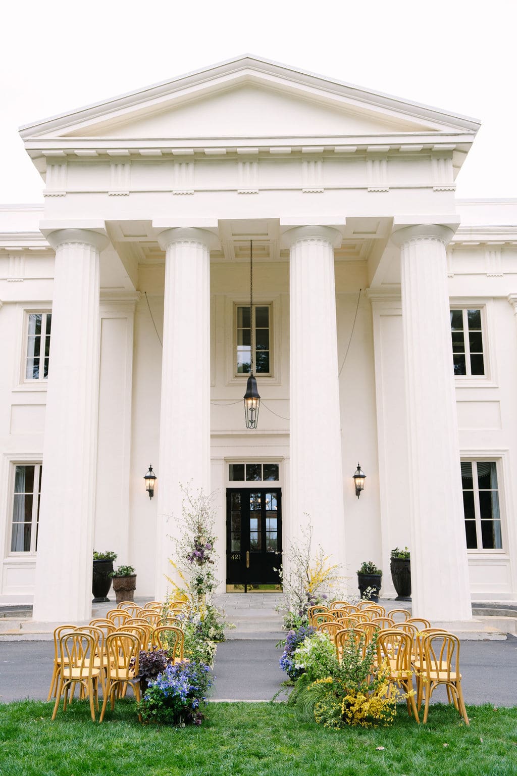 The Wadsworth Mansion at Long Hill Estate near Middletown, Connecticut, featuring its grand white-columned façade, elegant architecture, and landscaped grounds prepared for an outdoor event.