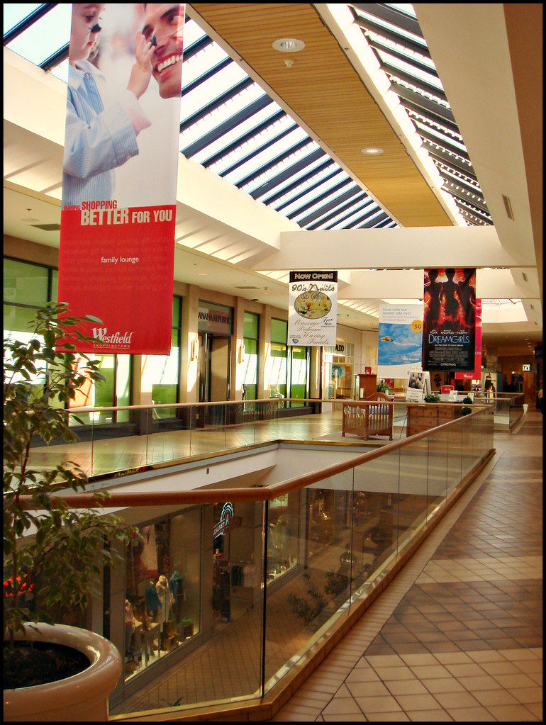 Interior view of Trumbull Mall in Trumbull, Connecticut, featuring a bright shopping concourse with storefronts, skylights, and an inviting indoor retail atmosphere.