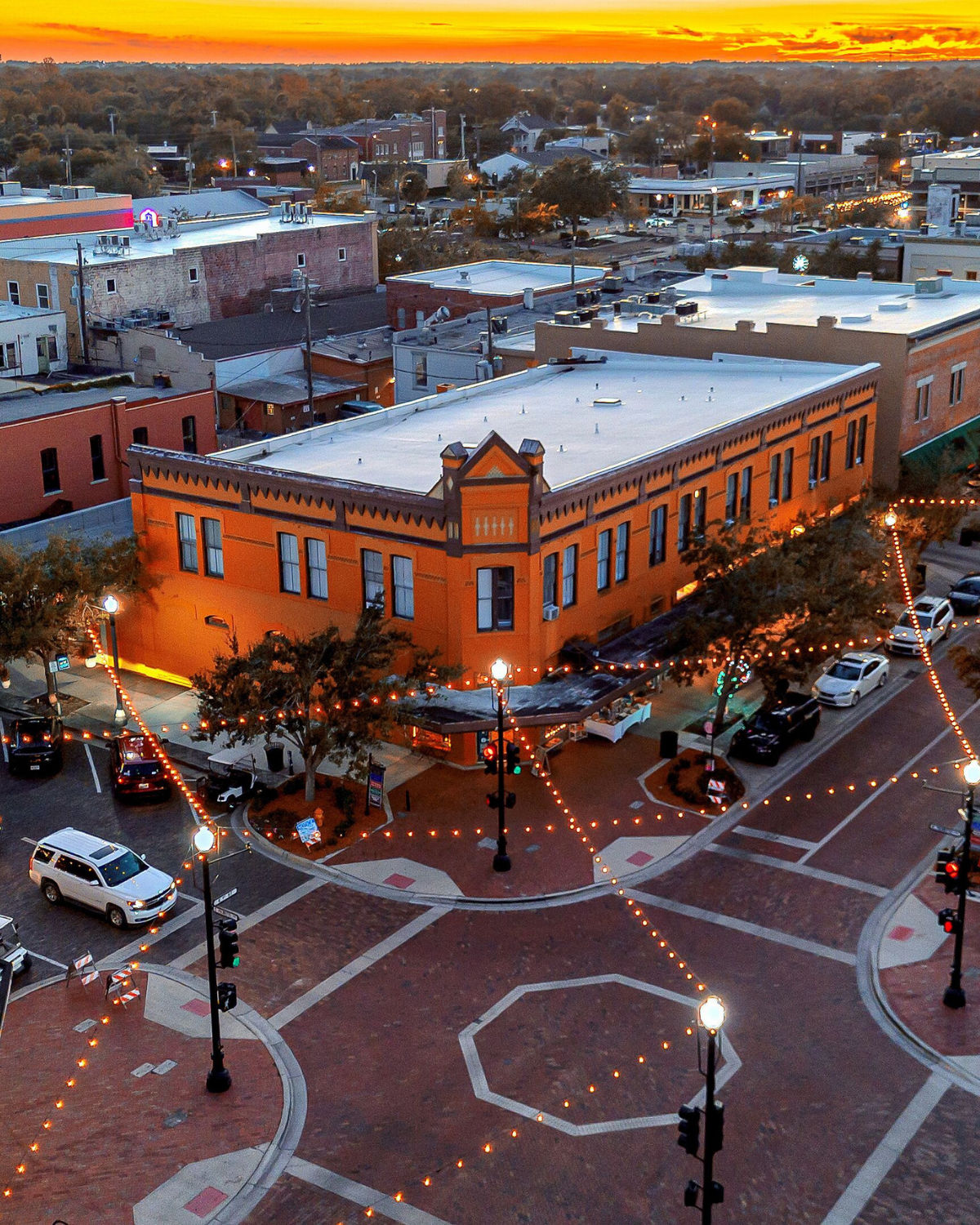 Aerial twilight view of Historic Downtown Sanford, FL with glowing brick streets and the Lake Monroe waterfront in the background+'[Southest + Midwest Tier 2 Pages 4.24.xlsx]city-page-template'!$L$32