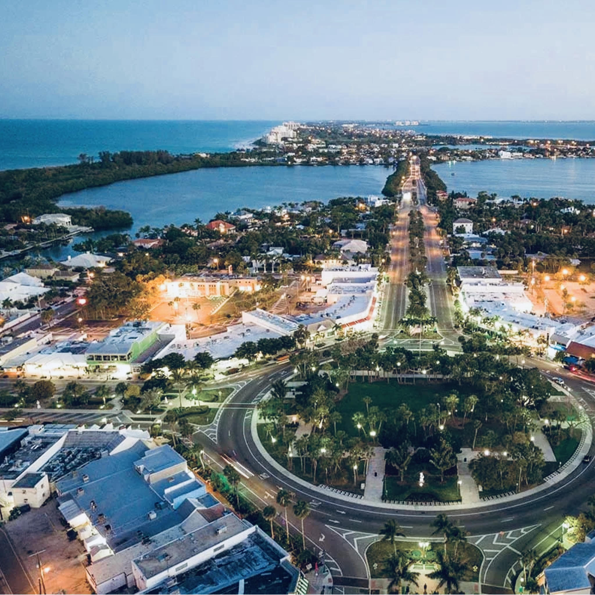 Aerial night view of downtown Sarasota, Florida with lit streets and waterfront