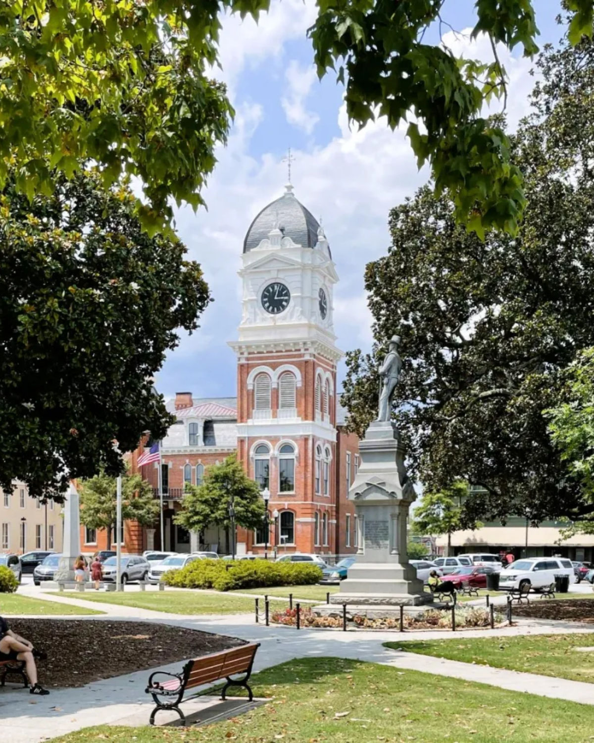 The stately white-columned Newton County Courthouse with a clock tower rising above the historic town square in Covington, Georgia