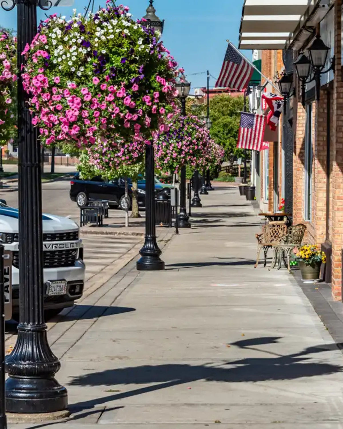 Scene of downtown in Crystal Lake, IL with storefronts lining the sidewalk