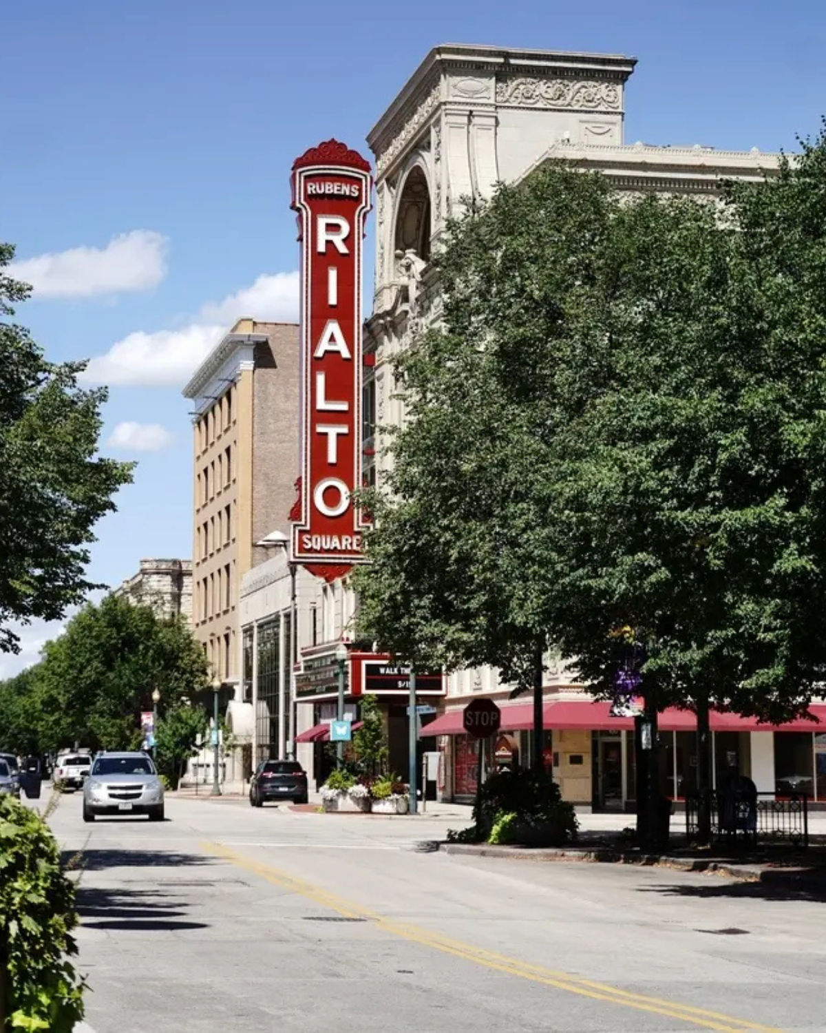 Street view of the historic Rialto Square Theatre and its large lit sign in Joliet, IL