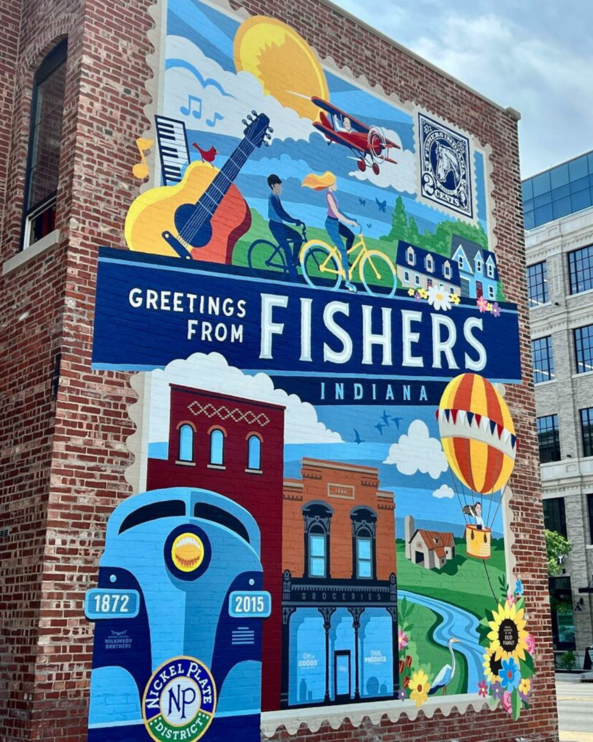 Wall art on the side of a brick building in the downtown area of Fishers, IN