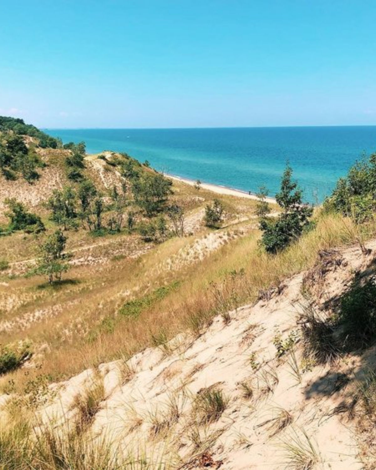 Sweeping aerial view of sandy dunes and blue Lake Michigan shoreline at Indiana Dunes National Park near Portage, Indiana