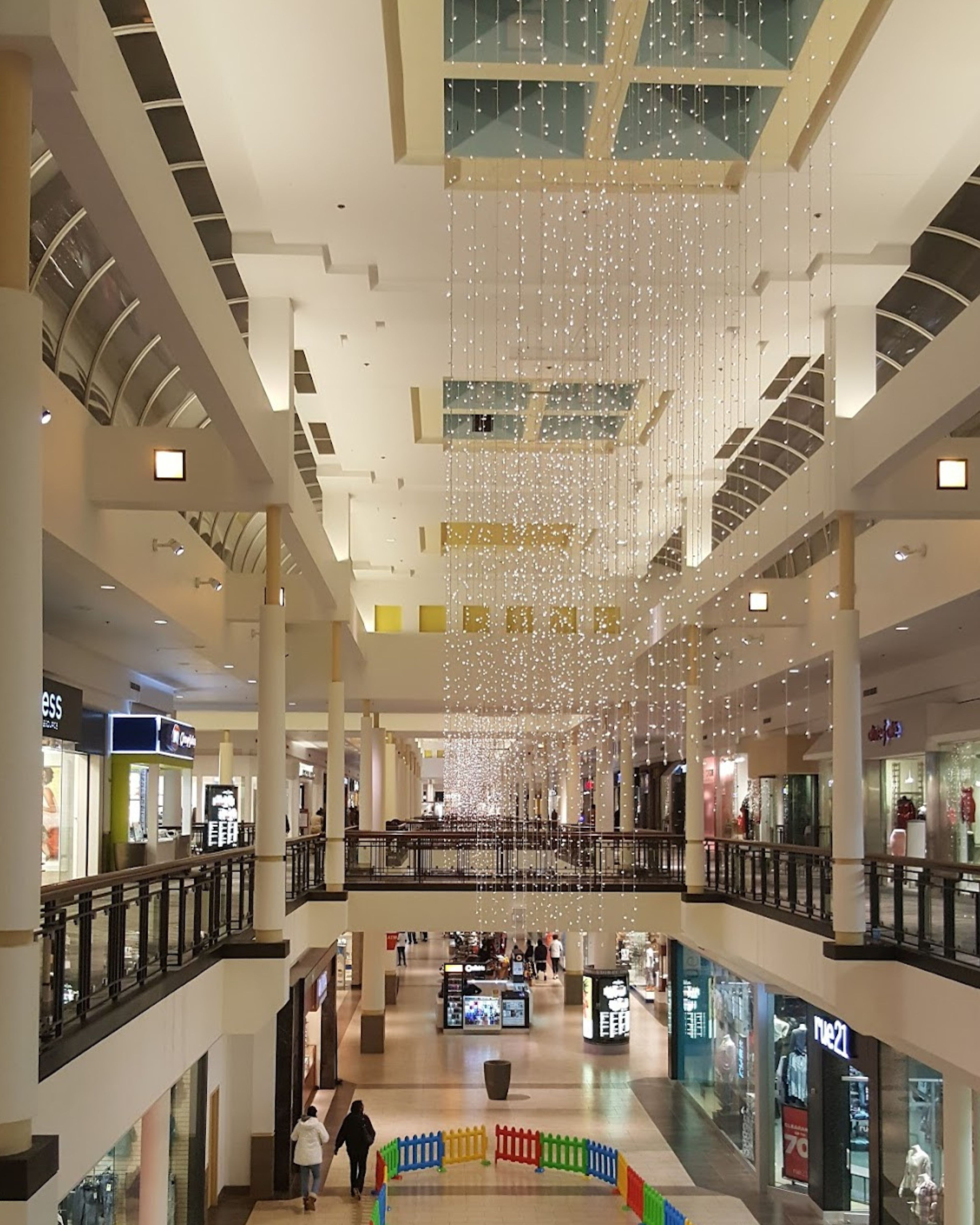 Interior of St. Charles Towne Center in Waldorf, Maryland, showcasing a spacious shopping mall with retail stores, skylights, and multi-level walkways.