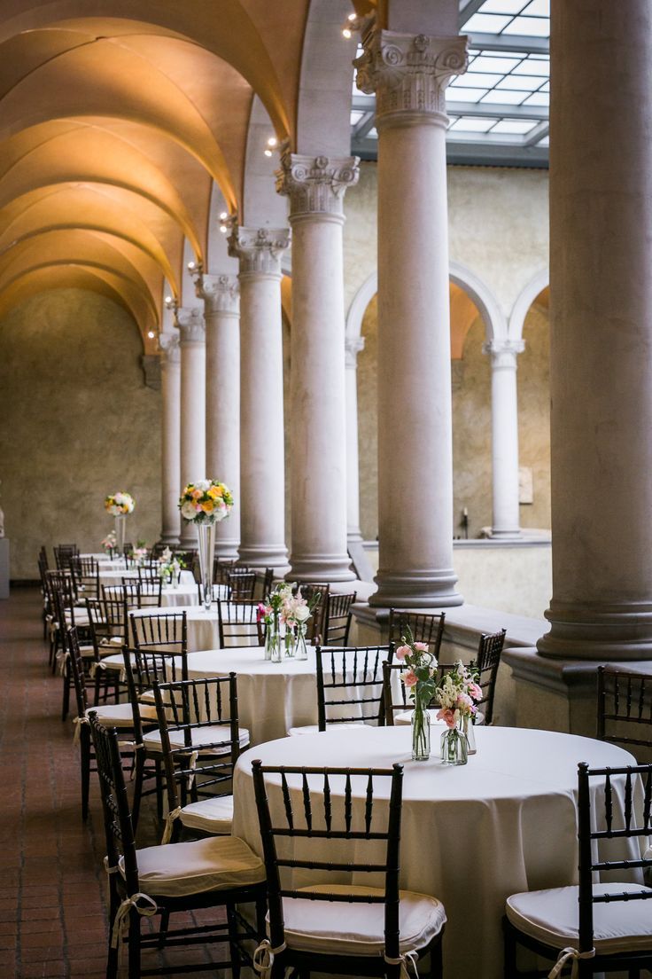 Interior of the Worcester Art Museum near North Grafton, Massachusetts, featuring a grand Renaissance-inspired hall with soaring columns, arched ceilings, and elegantly arranged banquet tables. The historic architectural space showcases the museum's distinctive blend of art, culture, and event venues.