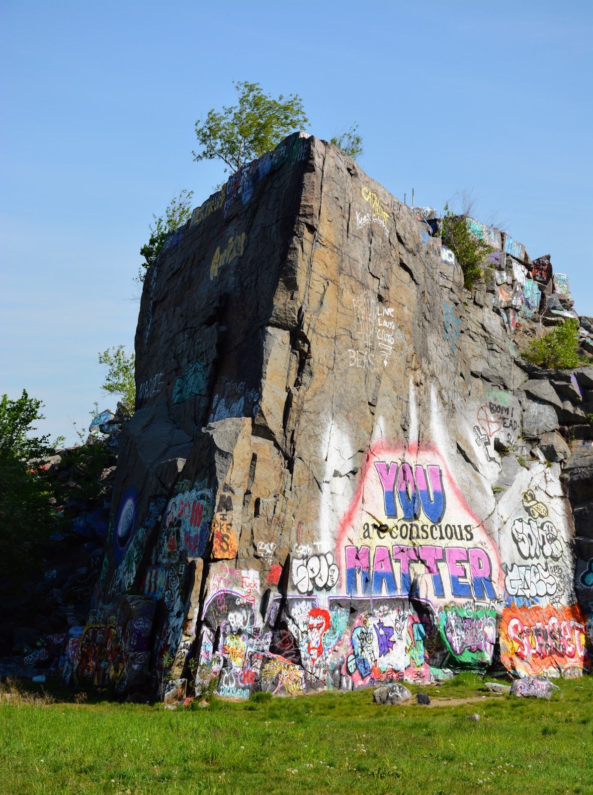 Granite rock formation at Quincy Quarries Reservation in Quincy, Massachusetts, featuring colorful graffiti murals and one of the area's most recognizable outdoor landmarks.