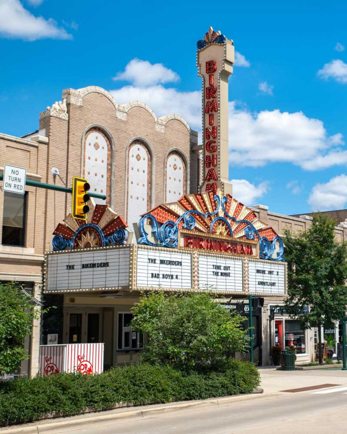 Street view of the historic Birmingham 8 theater with its towering original marquee in Birmingham, MI
